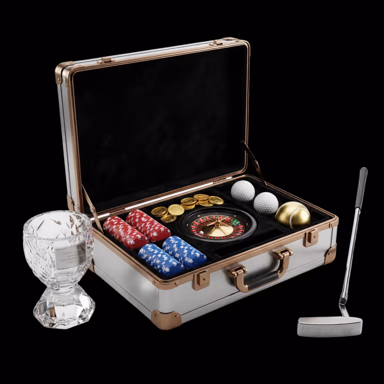 Gambyl Casino sports betting and interactive casino games display showing a luxury briefcase with a golf putter, golf balls, roulette wheel, and crystal trophy.